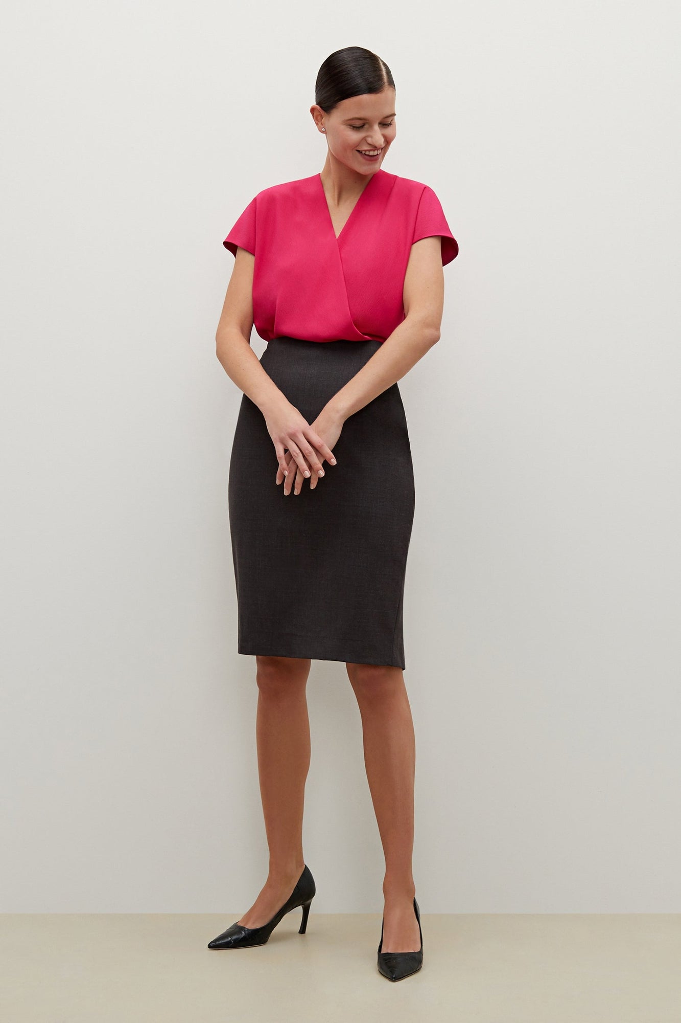 Front image of a woman standing wearing the Cobble Hill Skirt in Gray Melange | Grid Hover | Exclude