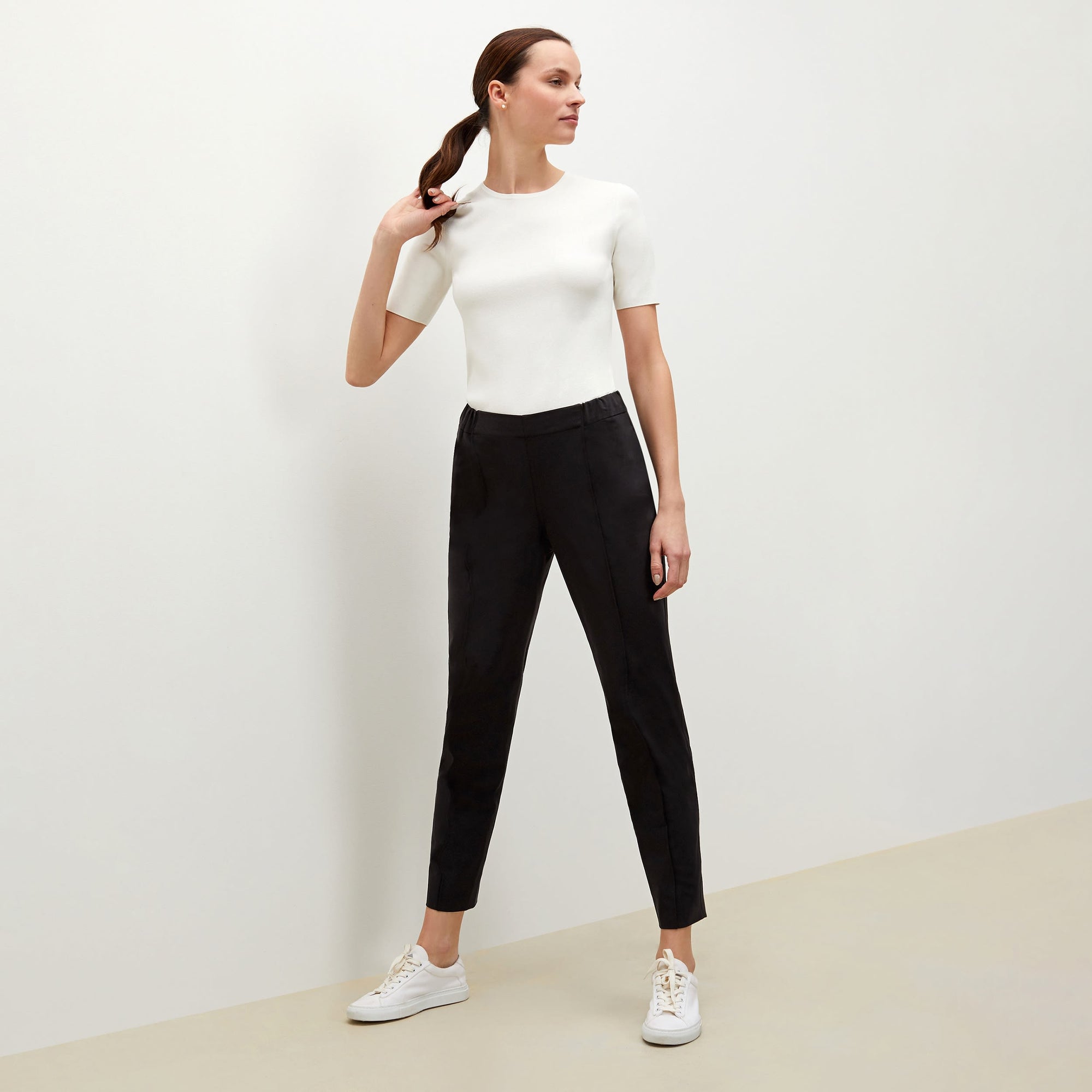 Side image of a woman standing wearing the Colby Jogger in Black | Exclude