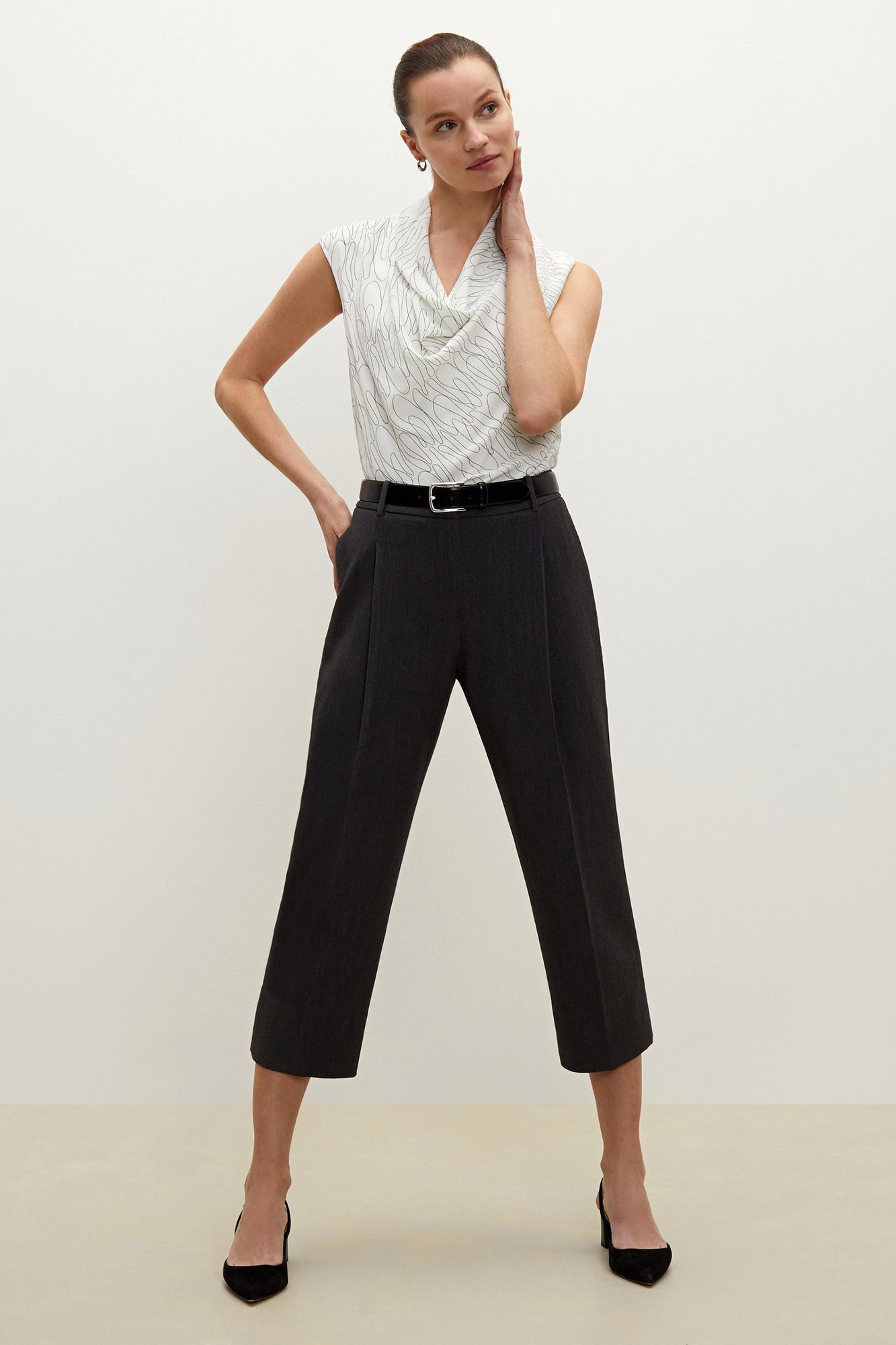 Front image of a woman standing wearing the Isadora pant in charcoal | Grid | Exclude