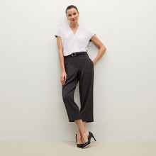 Side image of a woman standing wearing the Isadora pant in charcoal
