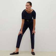 Front image of a woman standing wearing the Mejia pant in Galaxy Blue