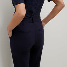Back image of a woman standing wearing the Mejia pant in Galaxy Blue
