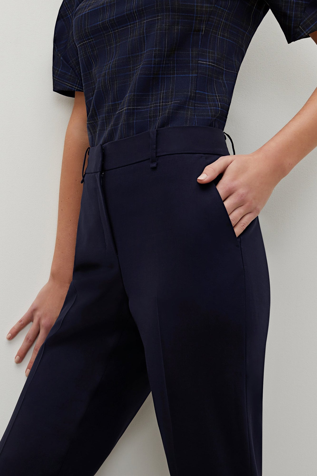 Side image of a woman standing wearing the Mejia pant in Galaxy Blue | Grid Hover | Exclude