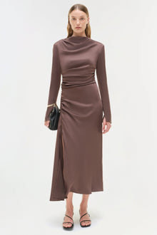 Taupe satin midi dress with long sleeves, ruched waist detail, and asymmetrical skirt hem.