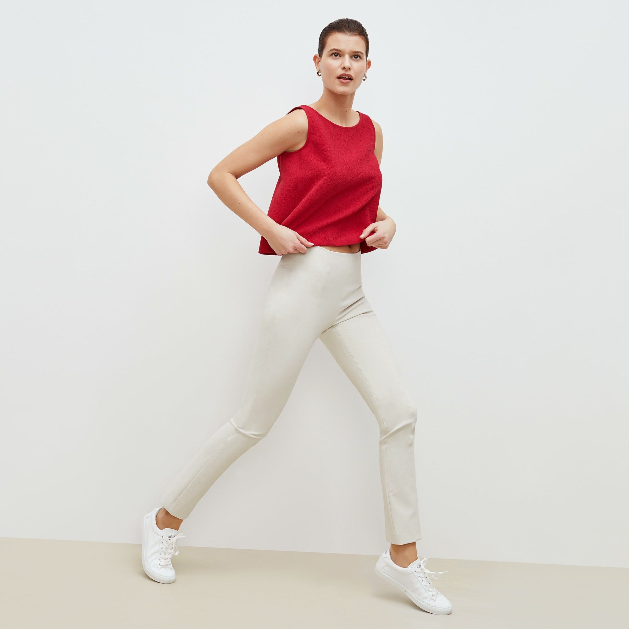 Side image of a woman standing wearing the foster pant in bone | Exclude