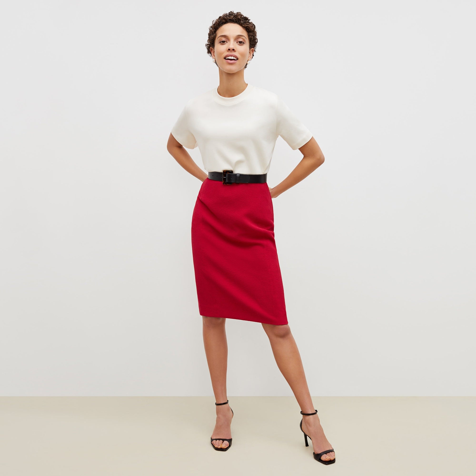 Front image of a woman standing wearing the leslie top in compact cotton in ivory | Exclude