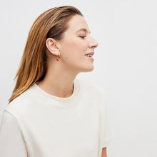 Detail image of a woman standing wearing the leslie top in compact cotton in ivory