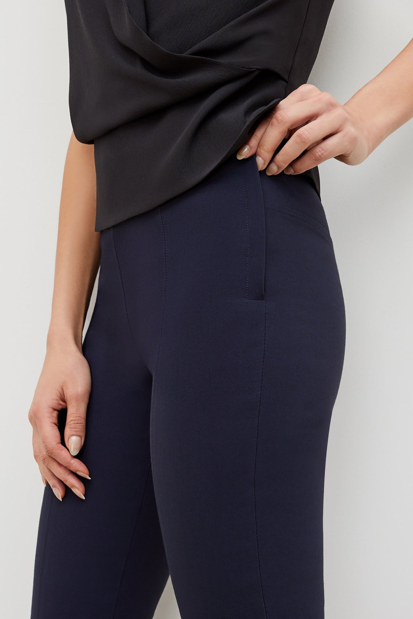 Side image of a woman standing wearing the foster pant in dark navy | Exclude