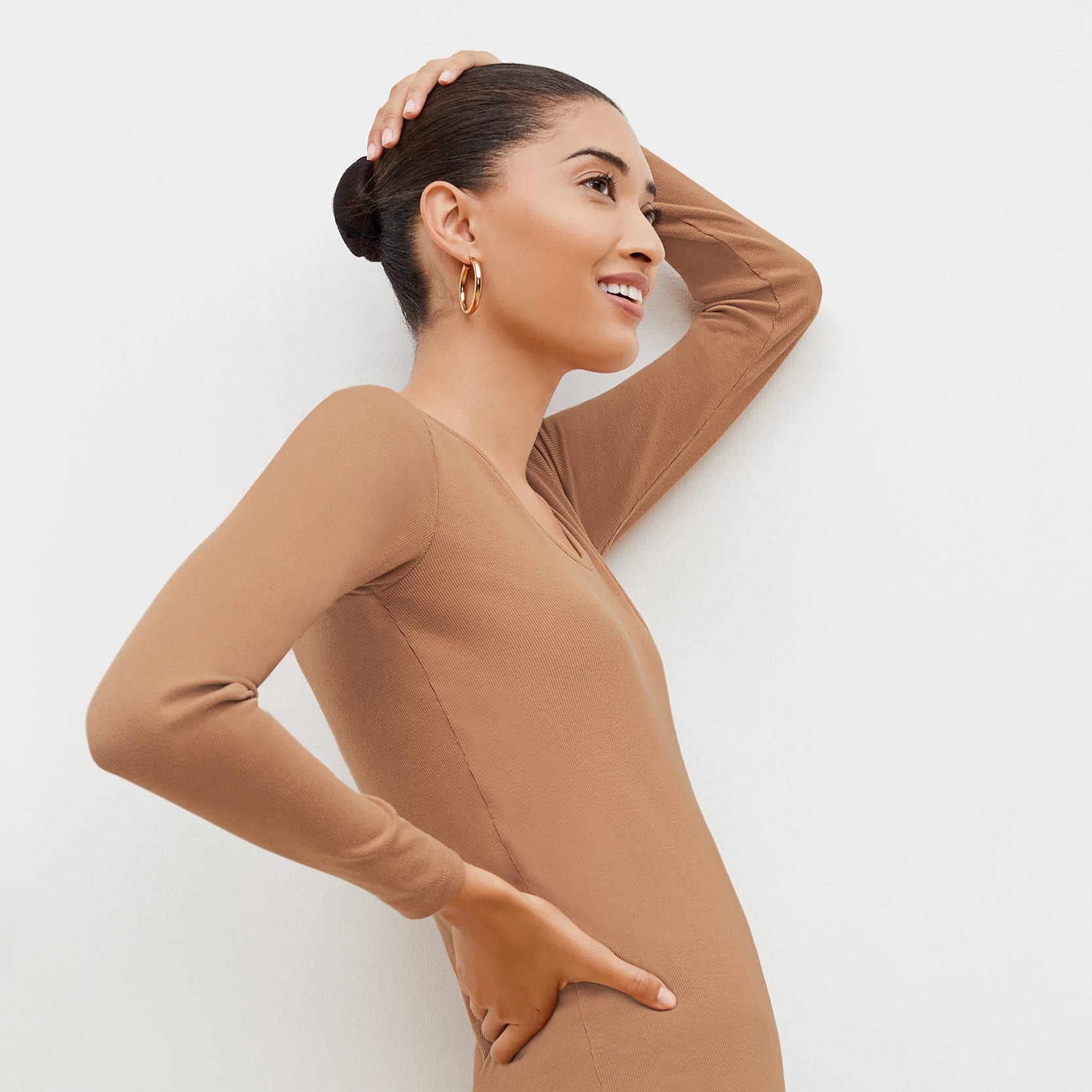 Side image of a woman standing wearing the marcia in camel | Exclude