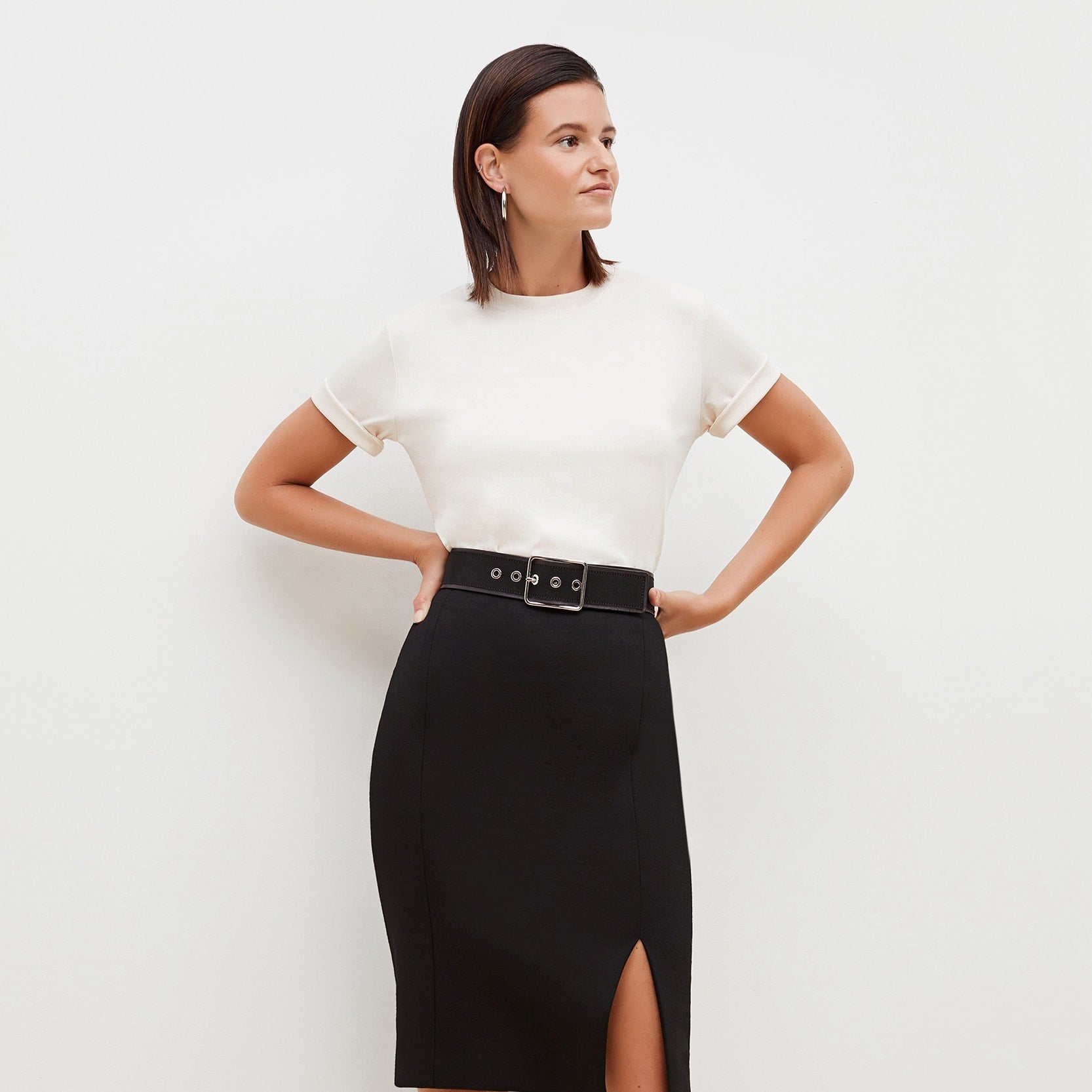 Front image of a woman standing wearing the leslie top in compact cotton in ivory | Exclude