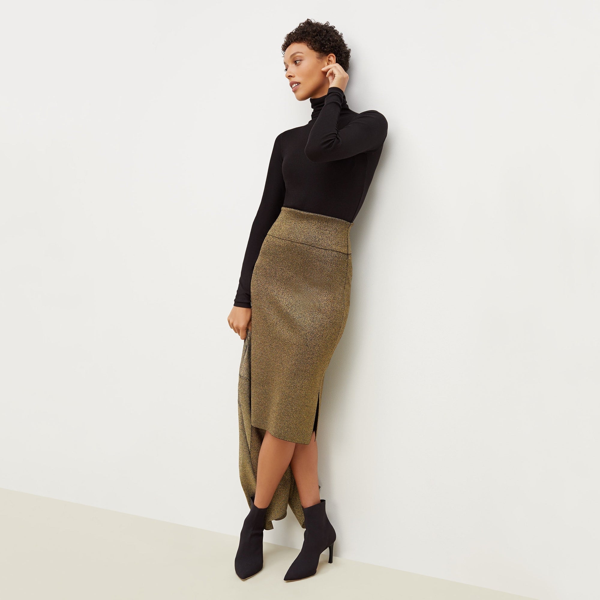 Front image of a woman standing wearing the axam top in black | Exclude
