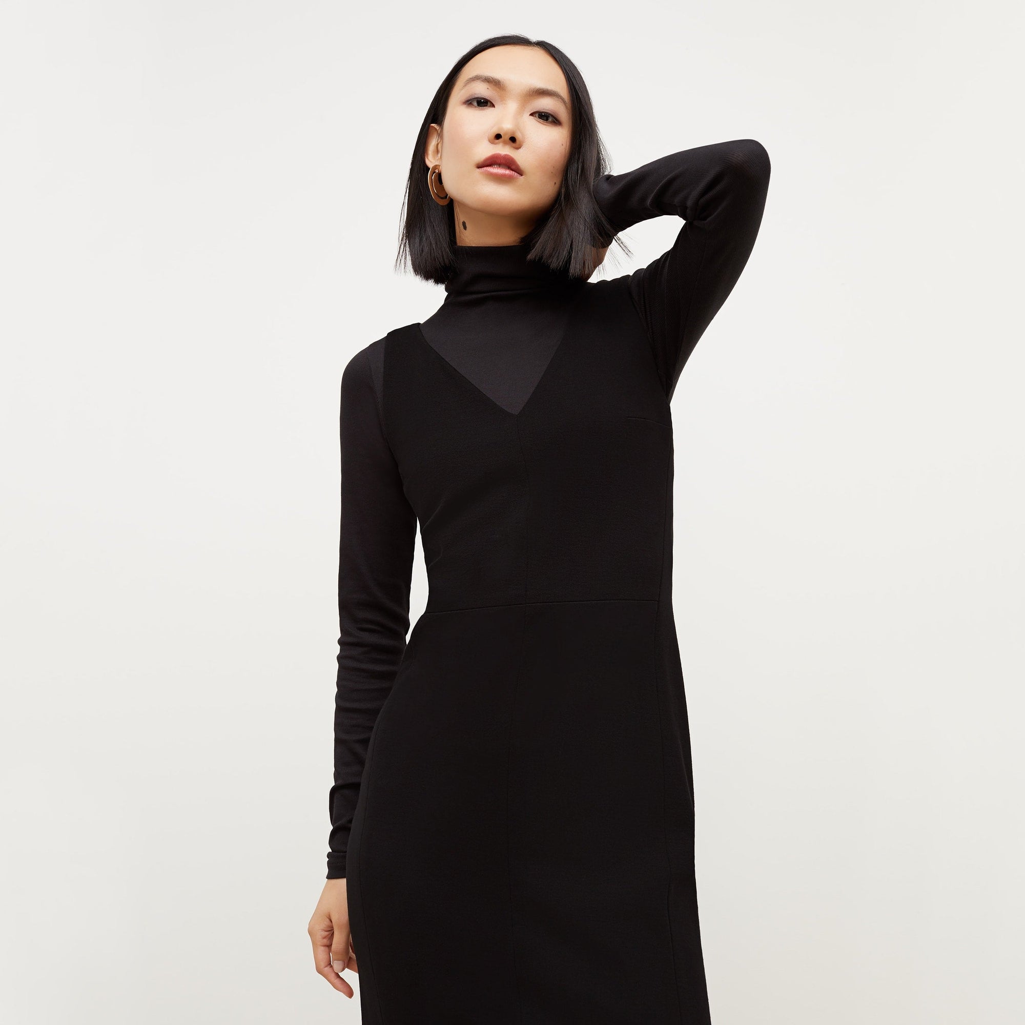Front image of a woman standing wearing the Rachel dress in black | Exclude