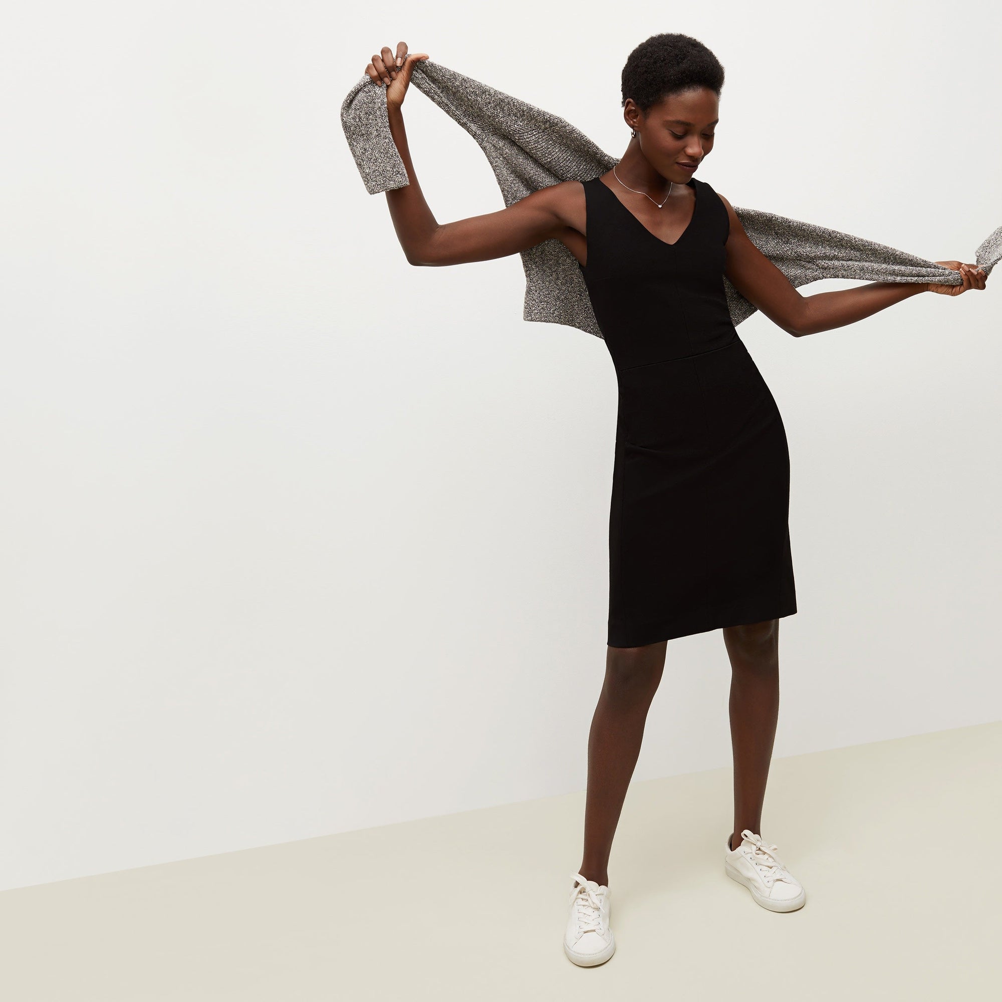 Front image of a woman standing wearing the Rachel dress in black