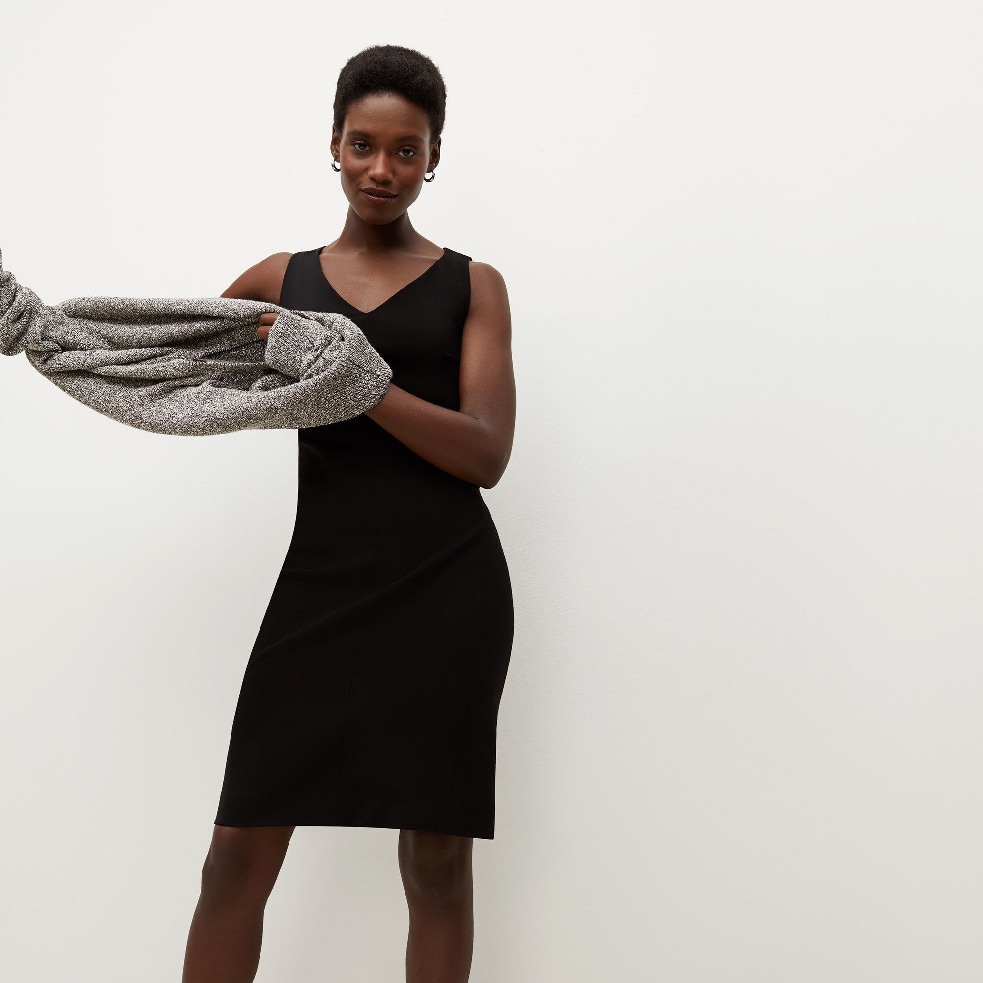 Front image of a woman standing wearing the Rachel dress in black | Exclude