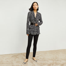 Front image of a woman standing wearing the curie pant in black