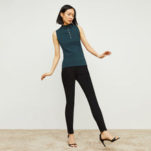 Front image of a woman standing wearing the curie pant in black | Lead