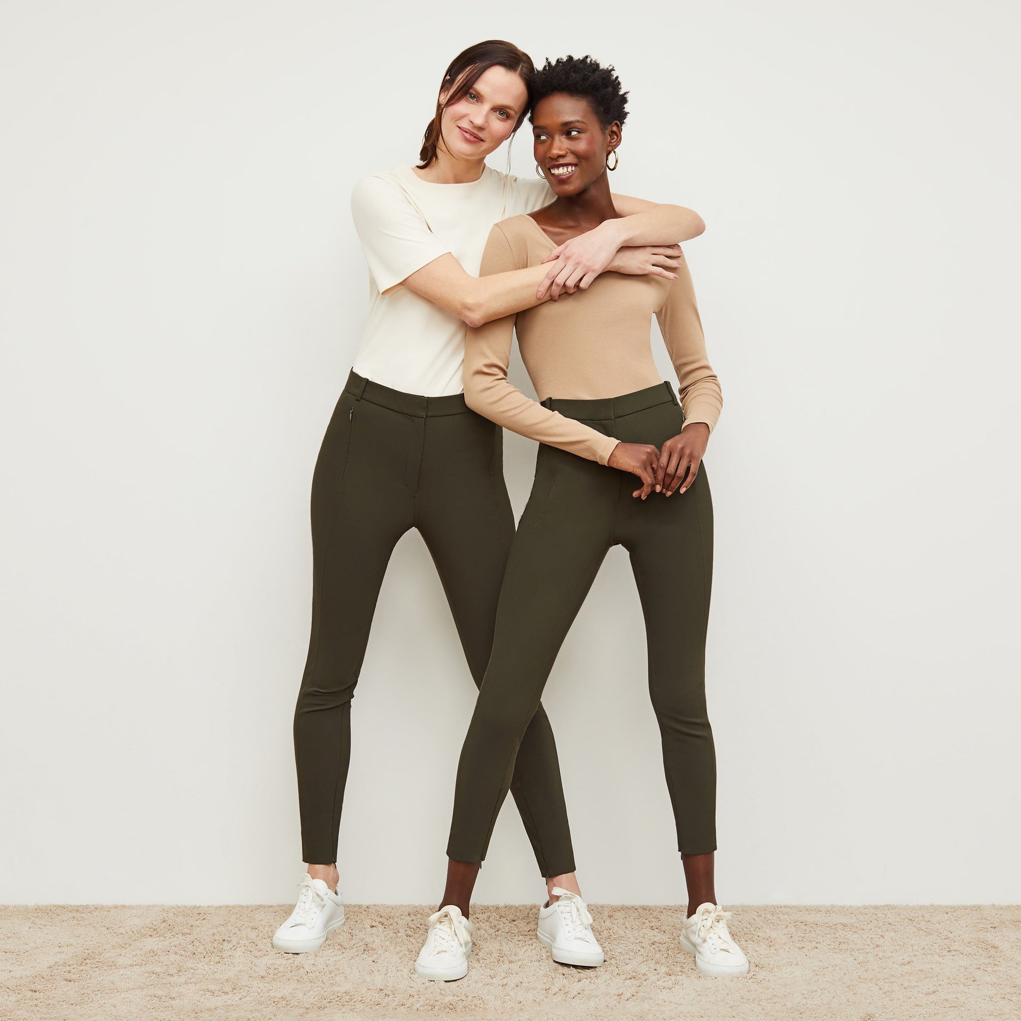Front image of a woman standing wearing the curie pant in dark olive | Lead