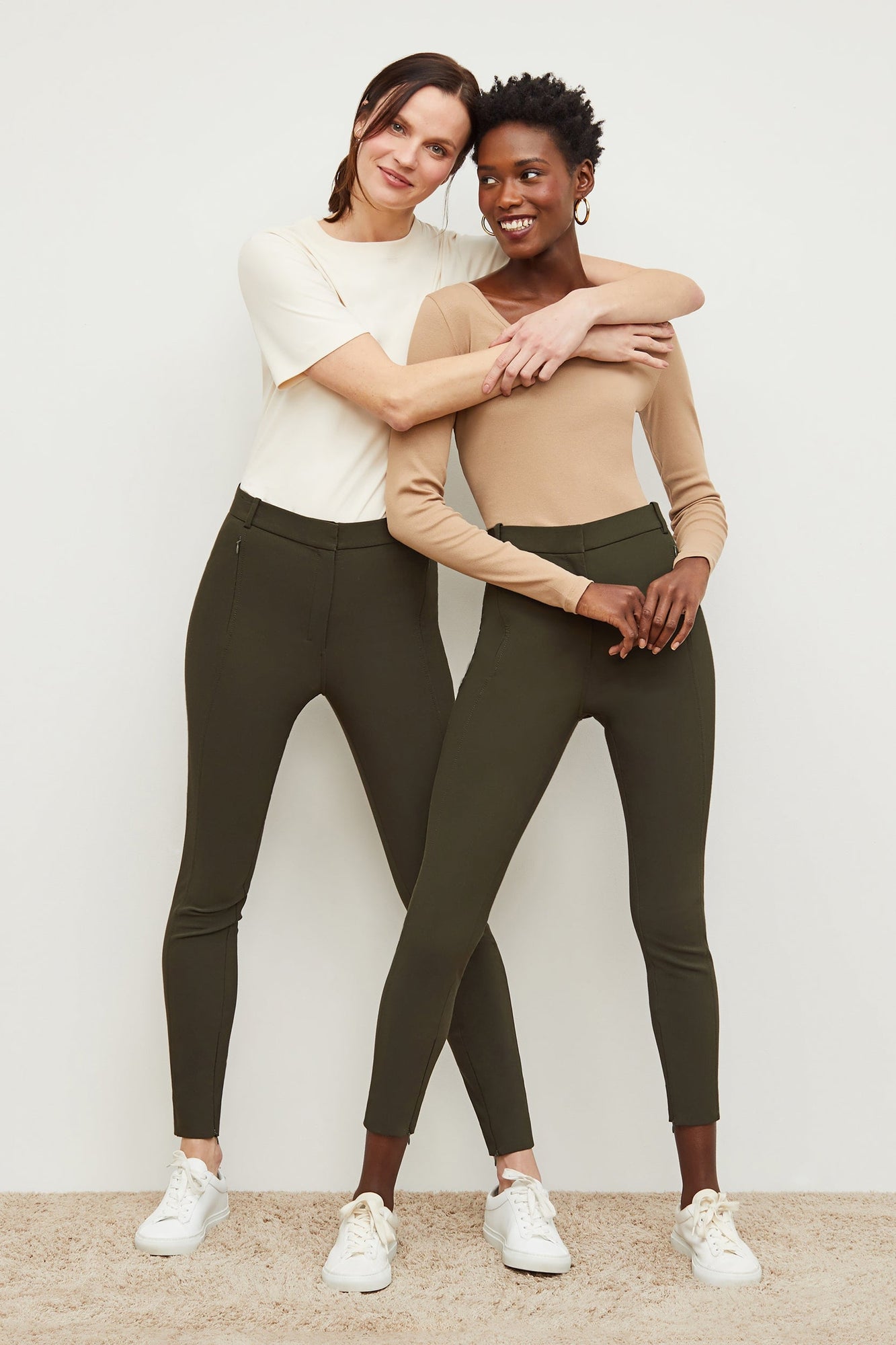 Front image of a woman standing wearing the curie pant in dark olive | Grid | Exclude