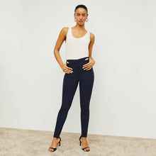 Front image of a woman standing wearing the curie pant in dark navy | Lead