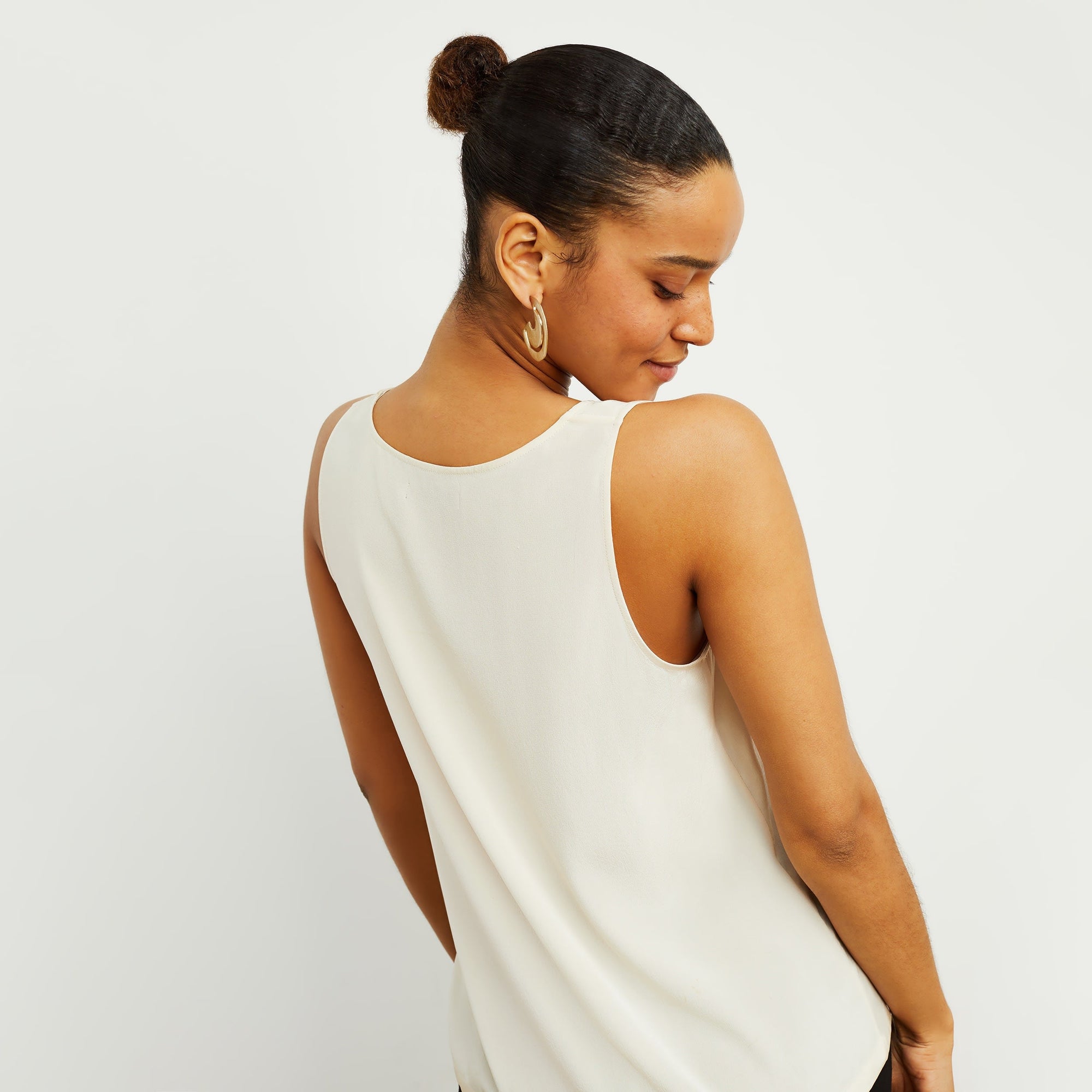 Back image of a woman standing wearing the Vicky Tank—Washable Silk in Pearl | Exclude