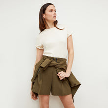 Front image of a woman standing wearing the leslie top in compact cotton in ivory