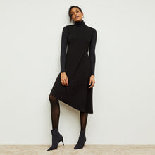 Front image of a woman standing wearing the Lara Dress in Black