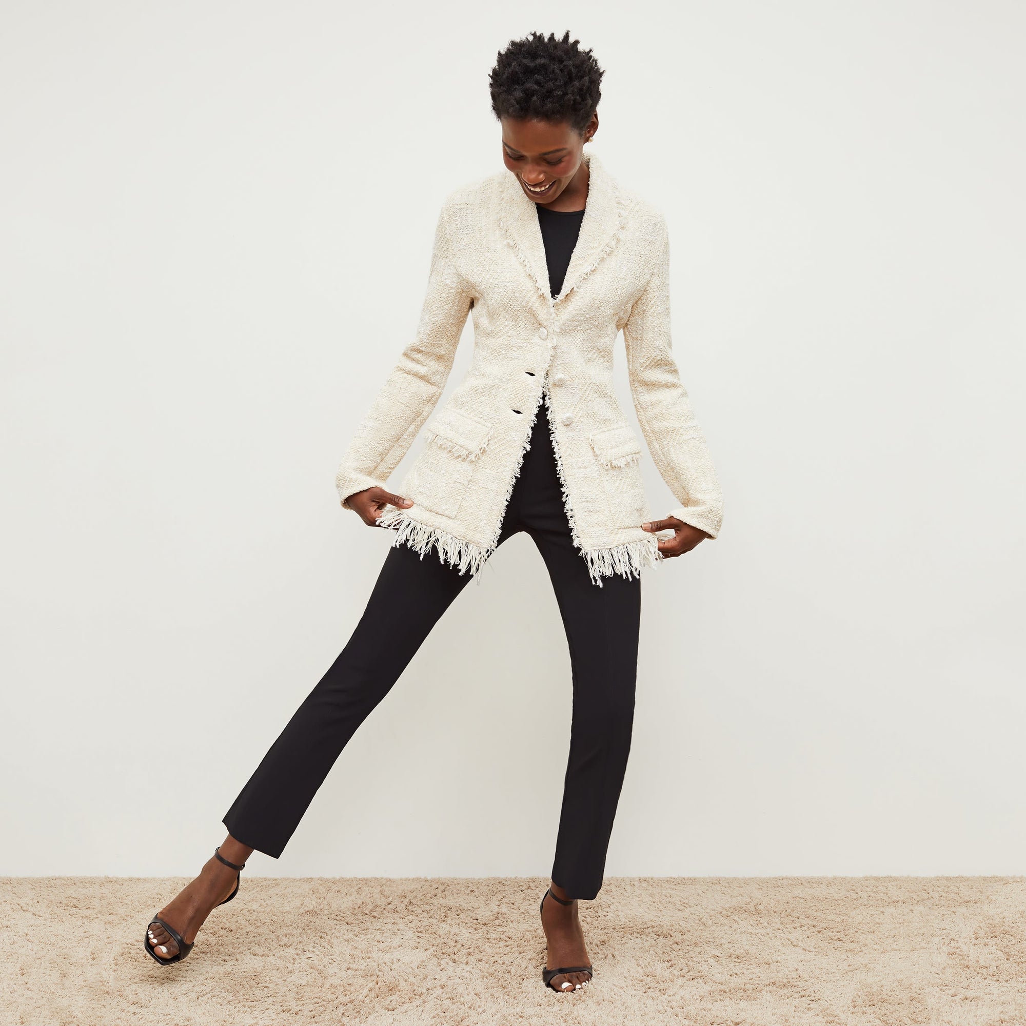 Front image of a woman standing wearing the Foster Pant—Everstretch in Black | Exclude