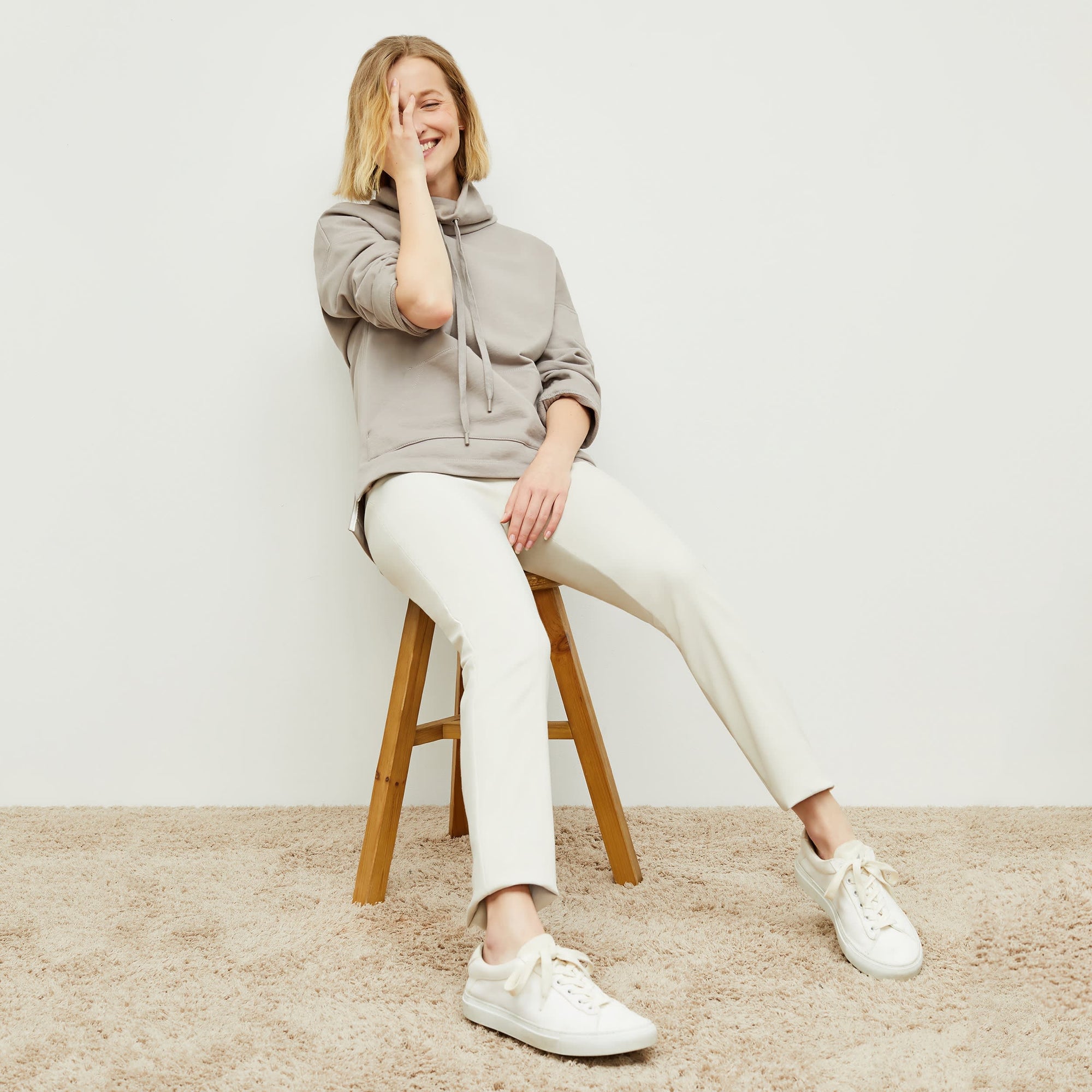 Front image of a woman standing wearing the foster pant in bone | Exclude