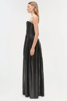 Black leather strapless bustier gown with floor-length skirt, shown from side view on model.