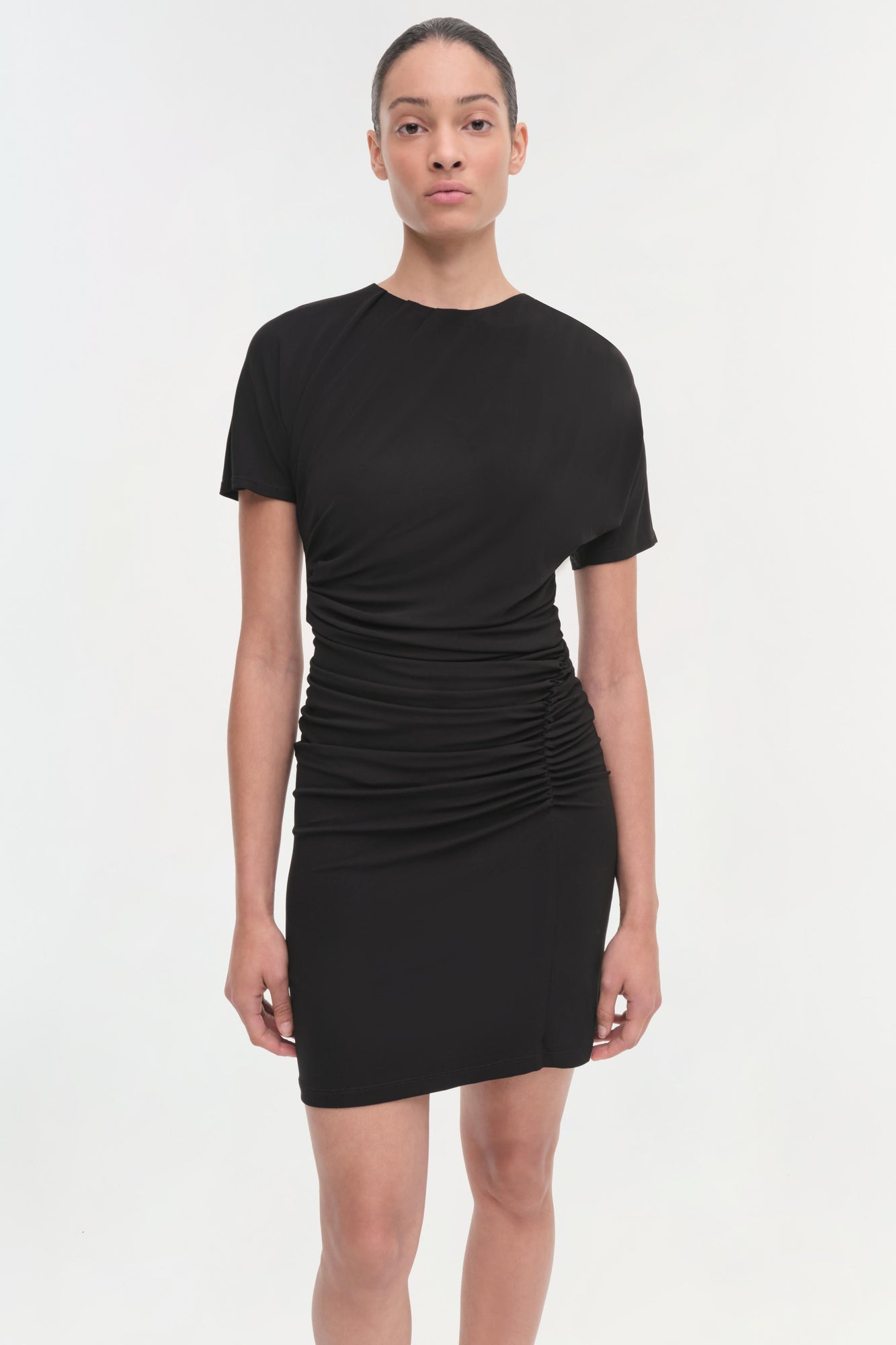 Black short-sleeve dress with ruched side detailing at the waist and hips.