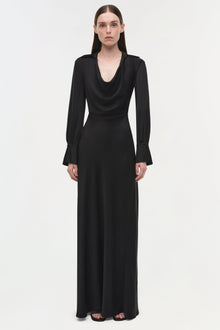 Black satin gown with draped cowl neckline, long sleeves with flared cuffs, and floor-length skirt.