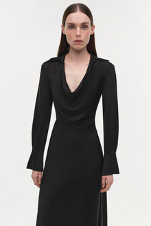 Black satin gown with draped cowl neckline, long bell sleeves, and fitted waist.