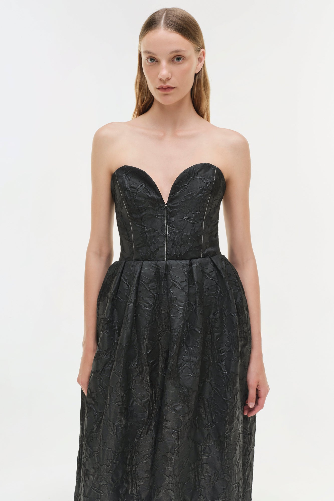 Black jacquard strapless bustier gown with sweetheart neckline and full skirt.