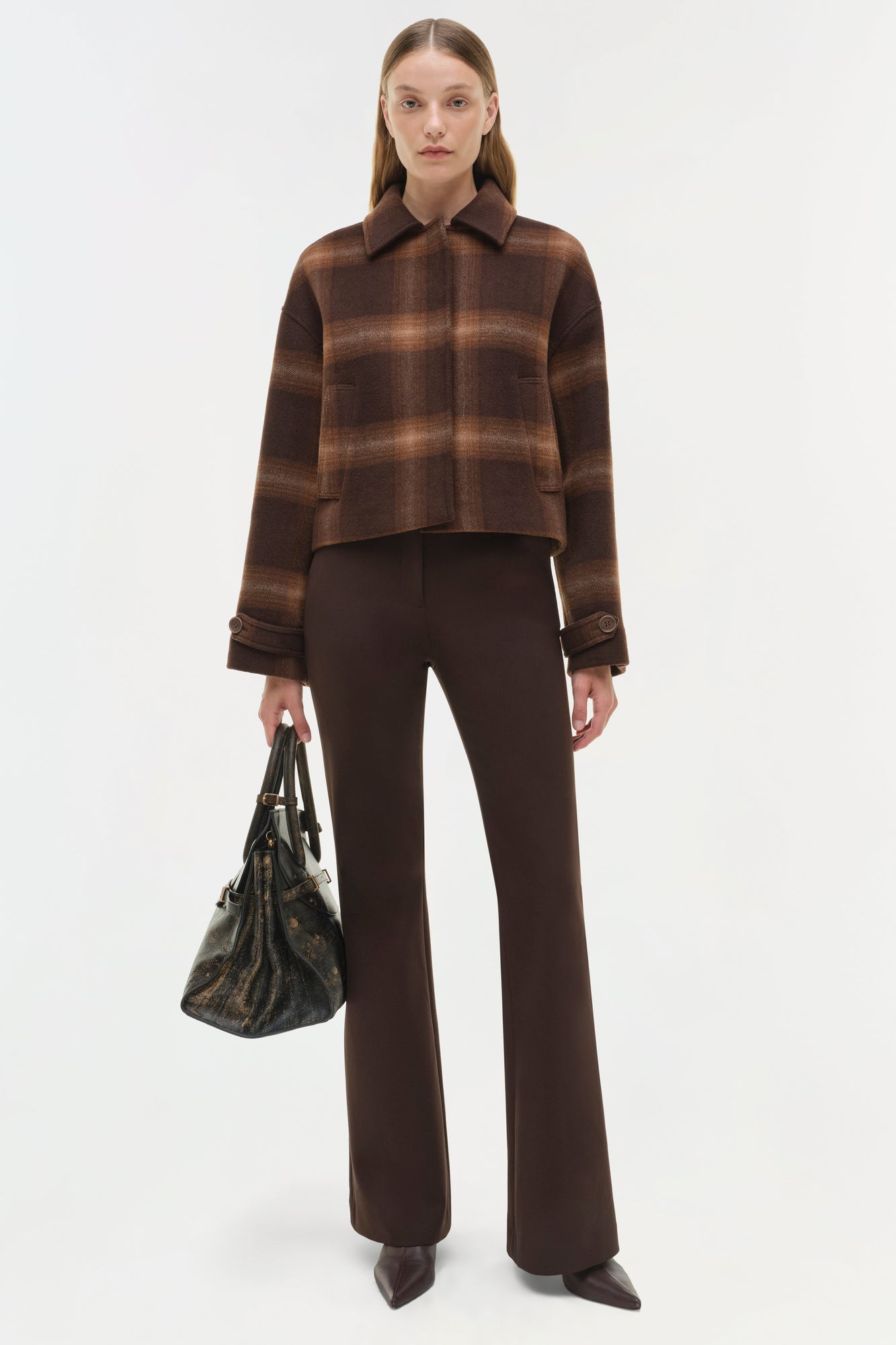 Brown plaid wool jacket with collar and front button closure, styled with matching brown pants.