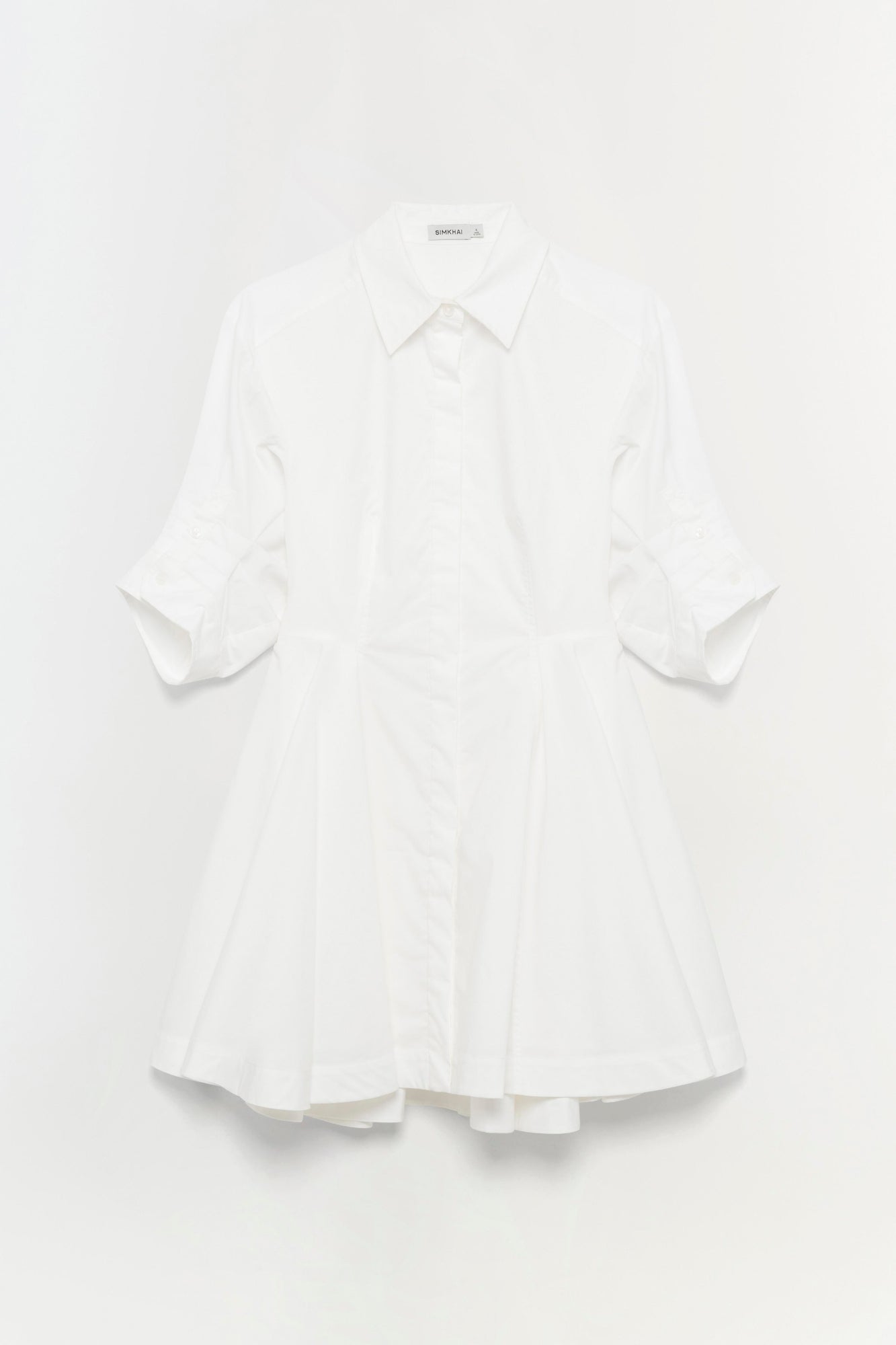 White button-up dress with collared neckline, three-quarter sleeves, and flared skirt.