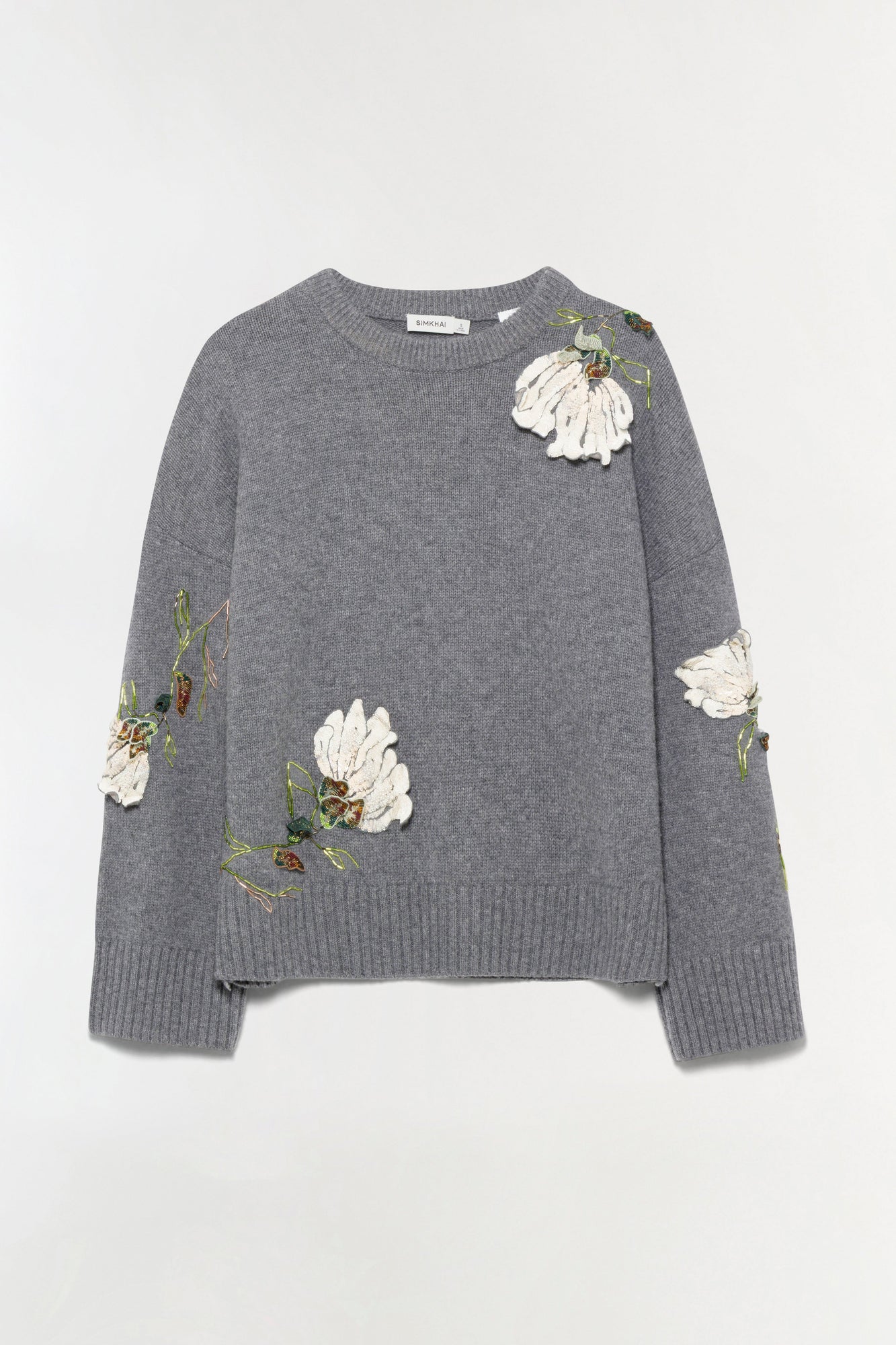 Gray knit sweater with white embroidered flowers and green stems scattered across chest and sleeves.