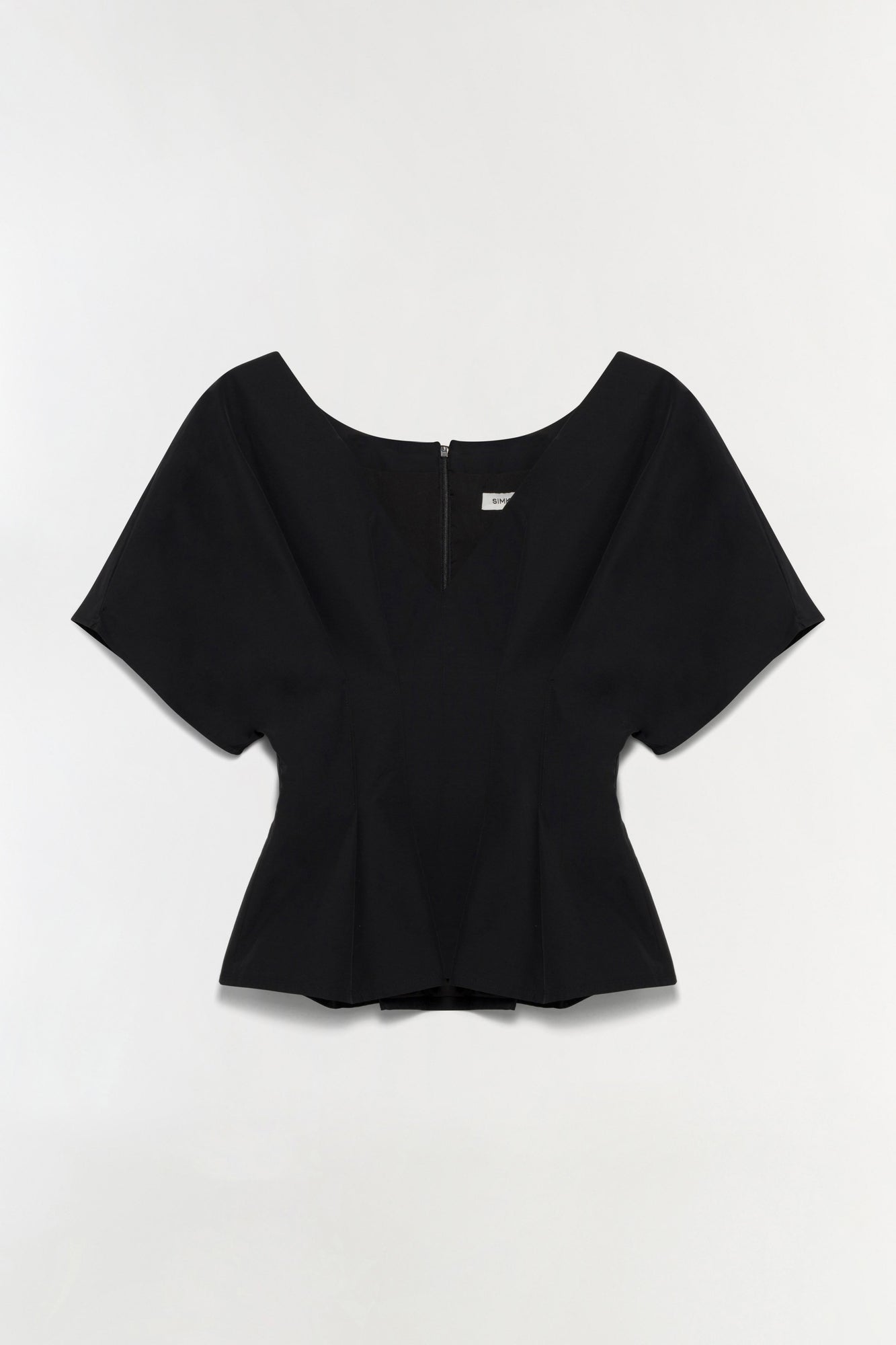 Black cotton faille top with short sleeves, scoop neckline, and peplum hem detail, shown flat lay from back.
