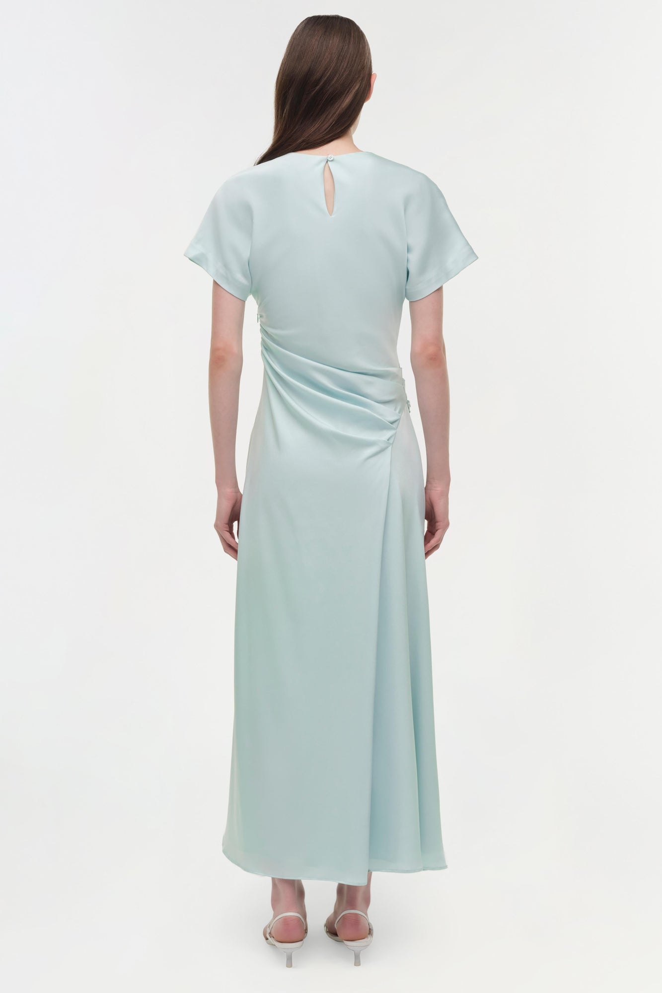 Light blue satin midi dress with short sleeves, draped side detail, and keyhole back neckline.