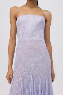 Lavender lace gown with thin straps, beaded detail lines, and pleated skirt hem.