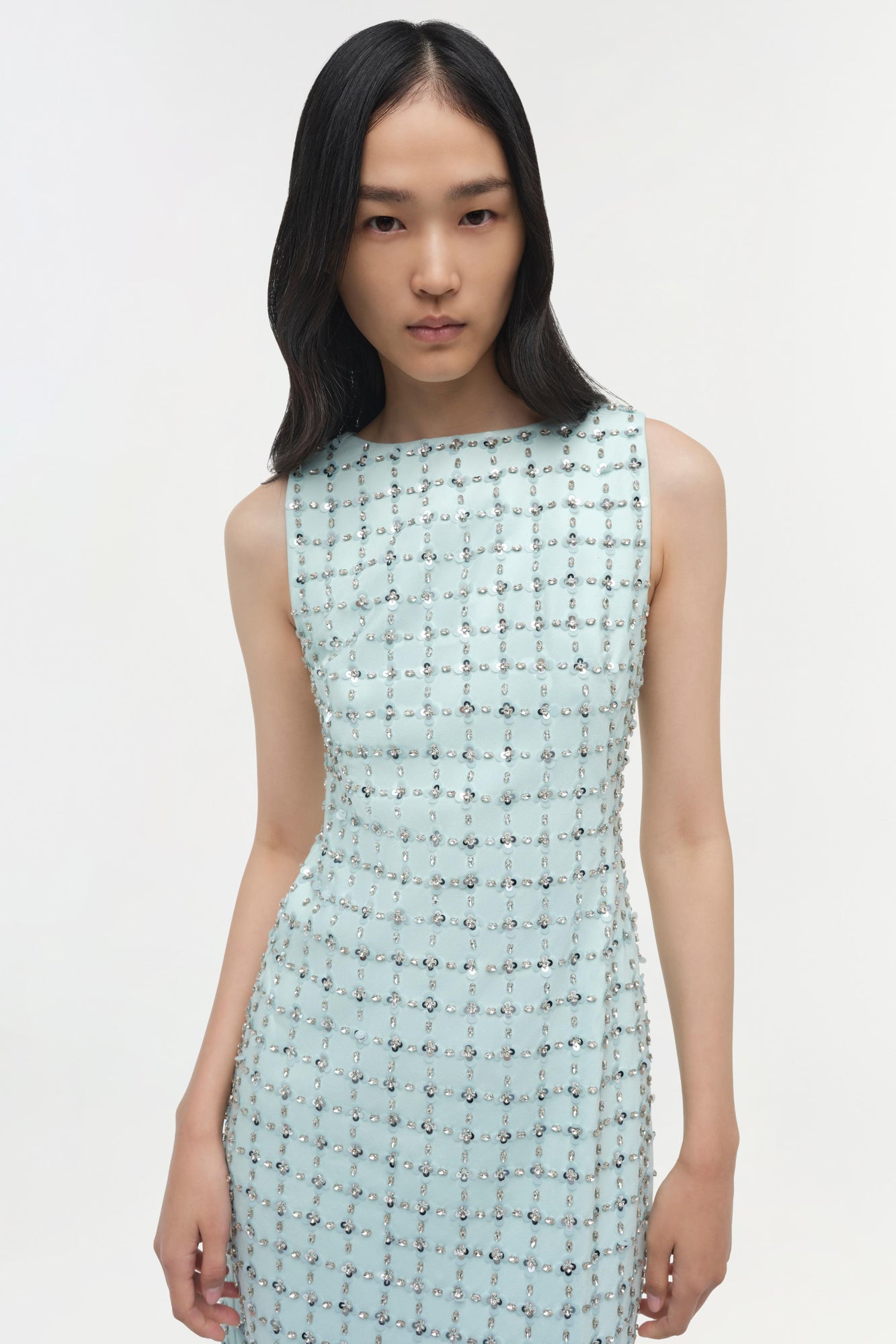 Light blue sleeveless midi dress with scattered crystal embellishments throughout.