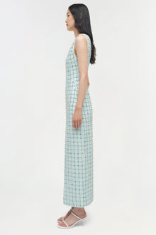 Light blue sleeveless midi dress with all-over sequin embellishments, shown on model in side profile view.
