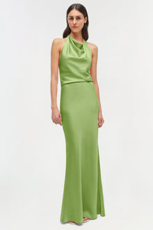 Woman wearing a lime green satin halter gown with a draped neckline and floor-length skirt.