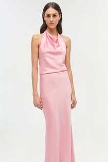 Woman wearing a pink satin halter gown with a draped neckline and fitted maxi skirt.