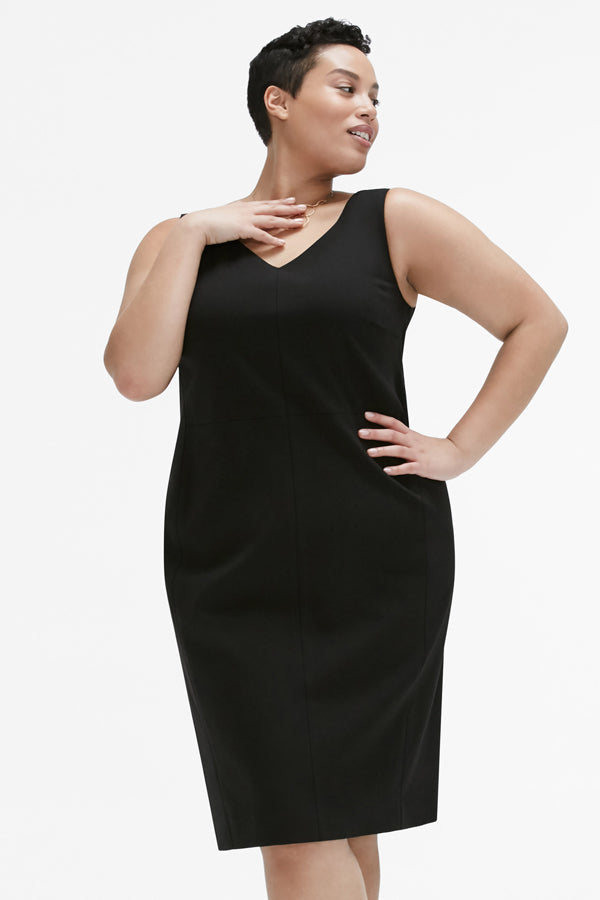 Front image of a woman standing wearing the Rachel dress in black | Plus | Exclude