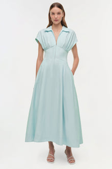 Light blue midi dress with short sleeves, collared neckline, fitted bodice, and full skirt with side pockets.