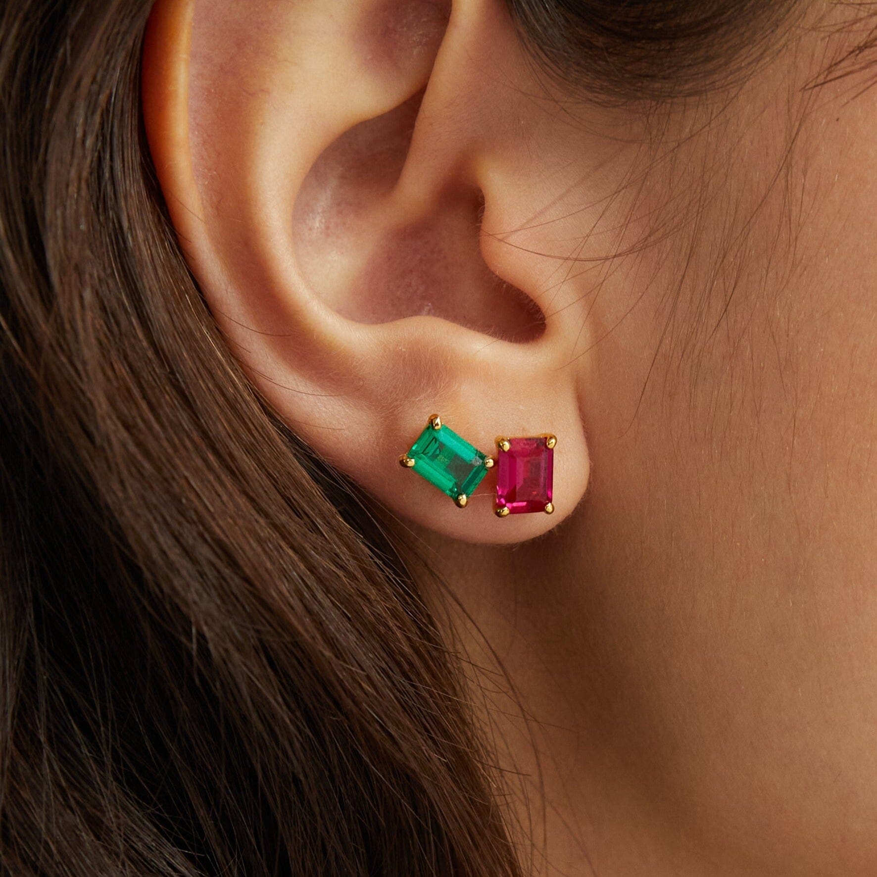 Lifestyle Model woman wearing two different color stud earrings close up