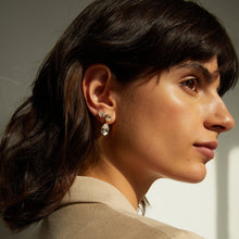 Lifestyle Model side profile of woman wearing diamond earrings