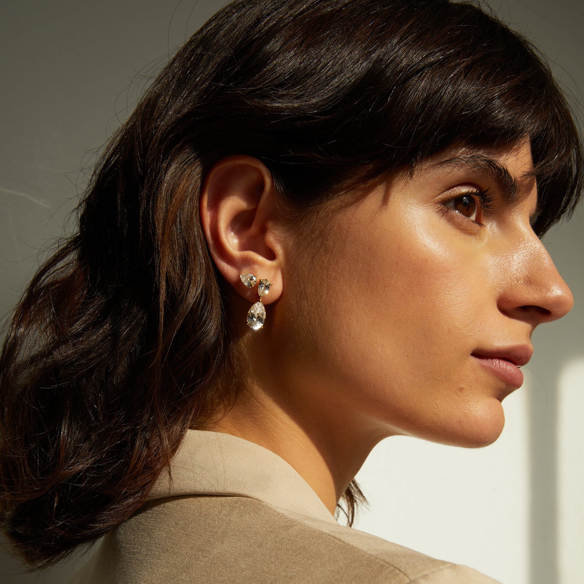 Lifestyle Model side profile of woman wearing diamond earrings