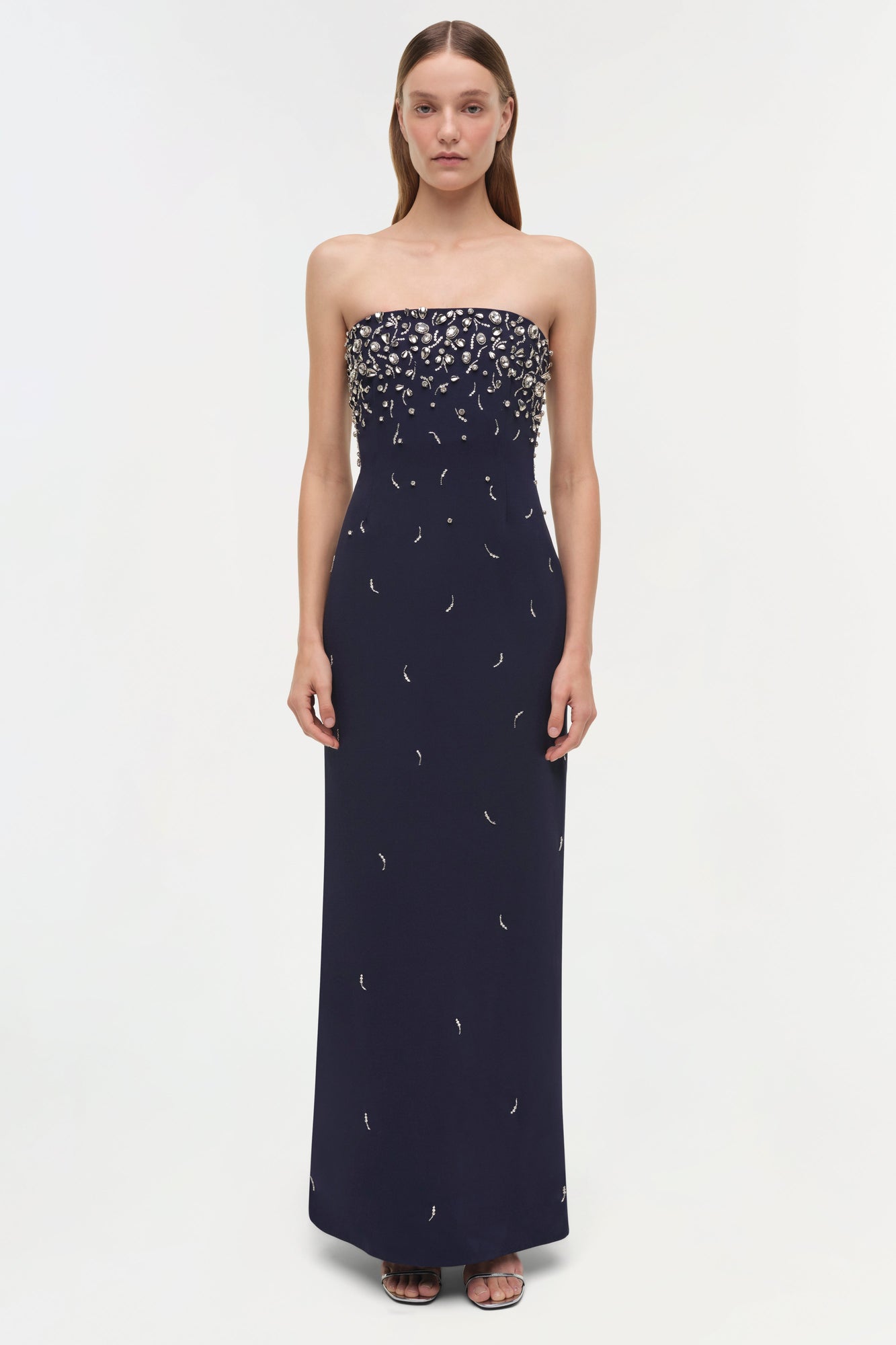 Navy strapless gown with scattered silver beading concentrated at neckline and dispersed down the floor-length skirt.
