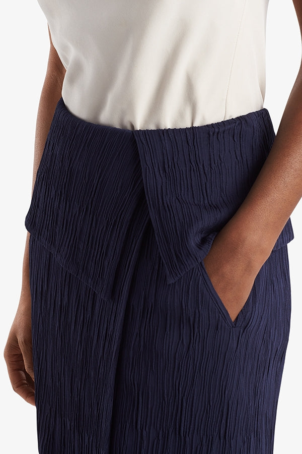 Side image of a woman standing wearing the Montgomery Skirt in aegean blue | Grid Hover | Exclude